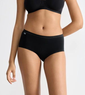 Model wearing sloggi Basic+ 4-pack black midi briefs for ultimate comfort and fit.