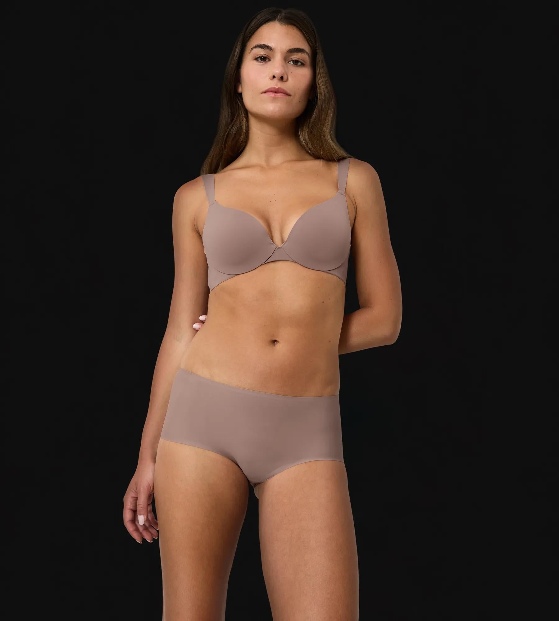 Model showcasing the Body Make-Up Illusion bra with deep cleavage effect and comfort features.