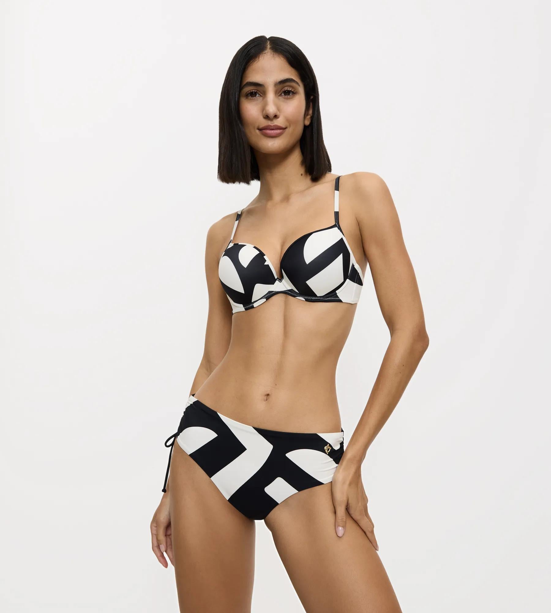 Model wearing Summer Allure sexy briefs with a stylish bikini top featuring vibrant black and white prints.