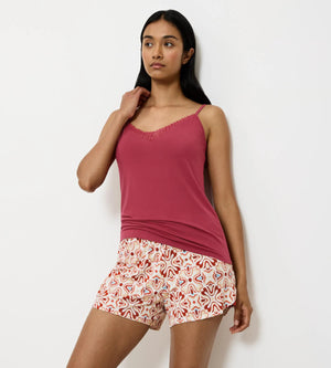 Aura Spotlight camisole featuring delicate lace, worn with colorful patterned shorts, perfect for stylish sleepwear.