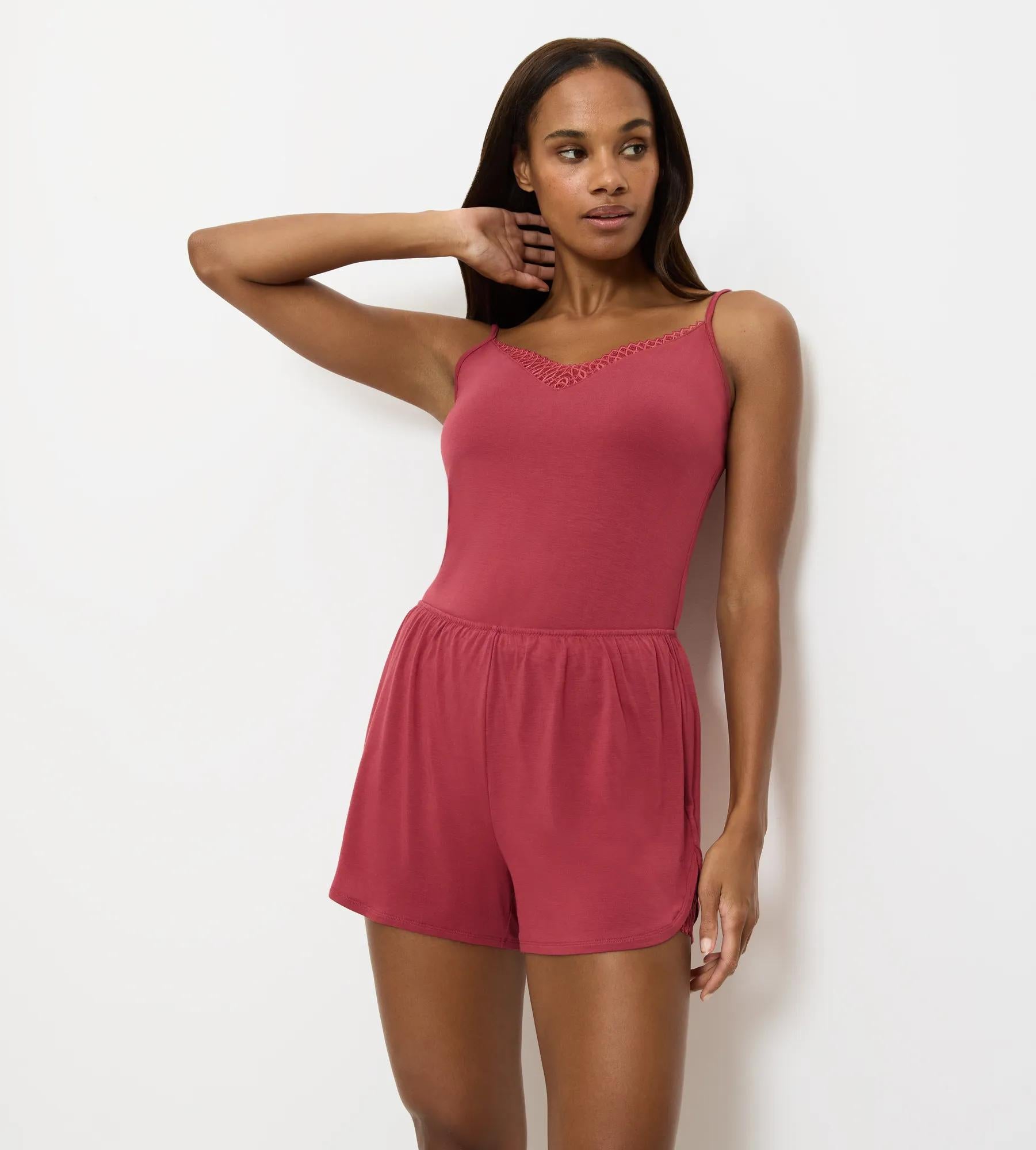 Aura Spotlight luxurious pyjama shorts with delicate lace insert for style and relaxation.