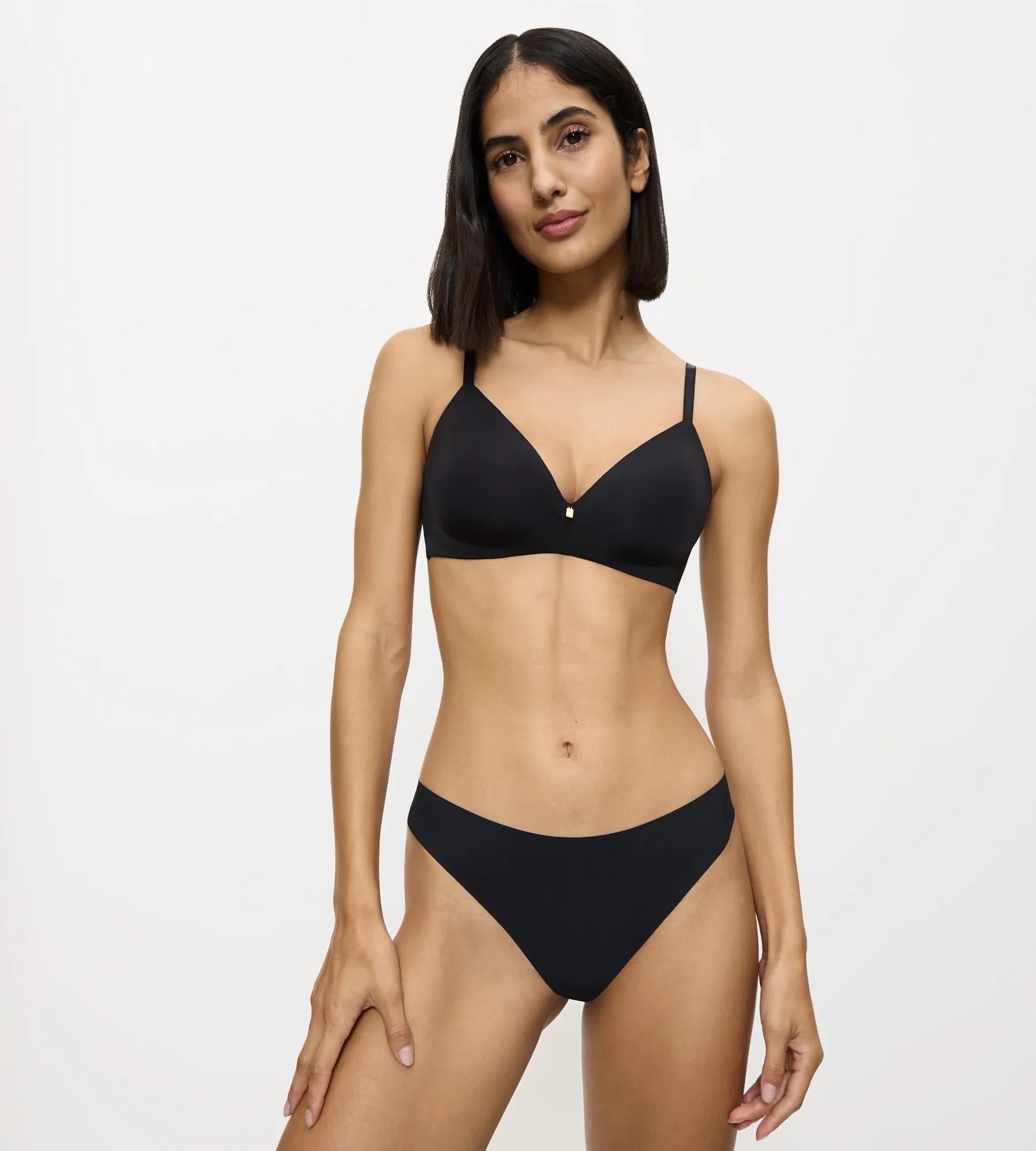Model wearing Pretty Micro black lace bra and low-coverage string brief, showcasing ultimate comfort and style.