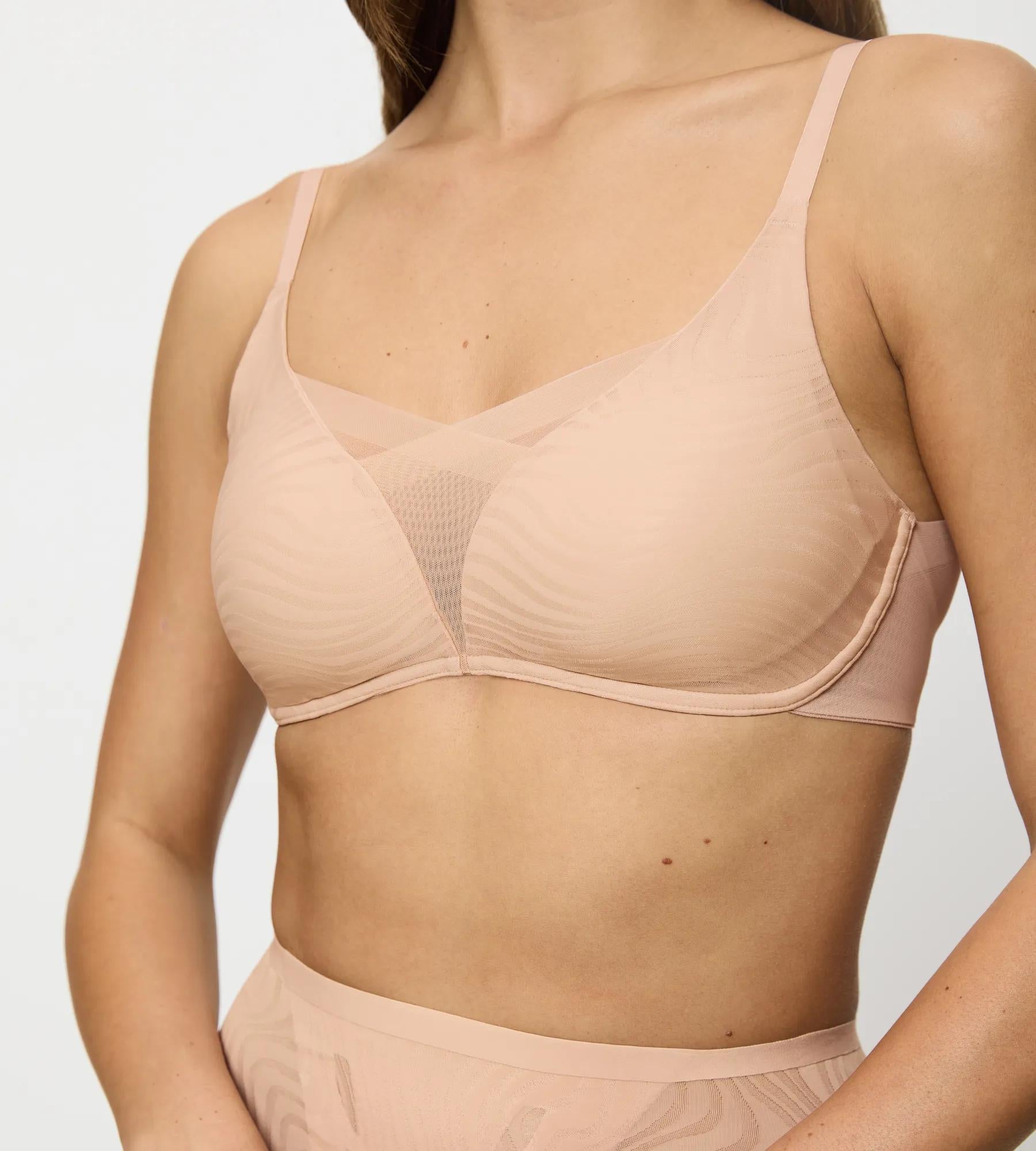 Model wearing Triumph Shape Smart Ellipse bra featuring non-wired padded support and mesh layering.