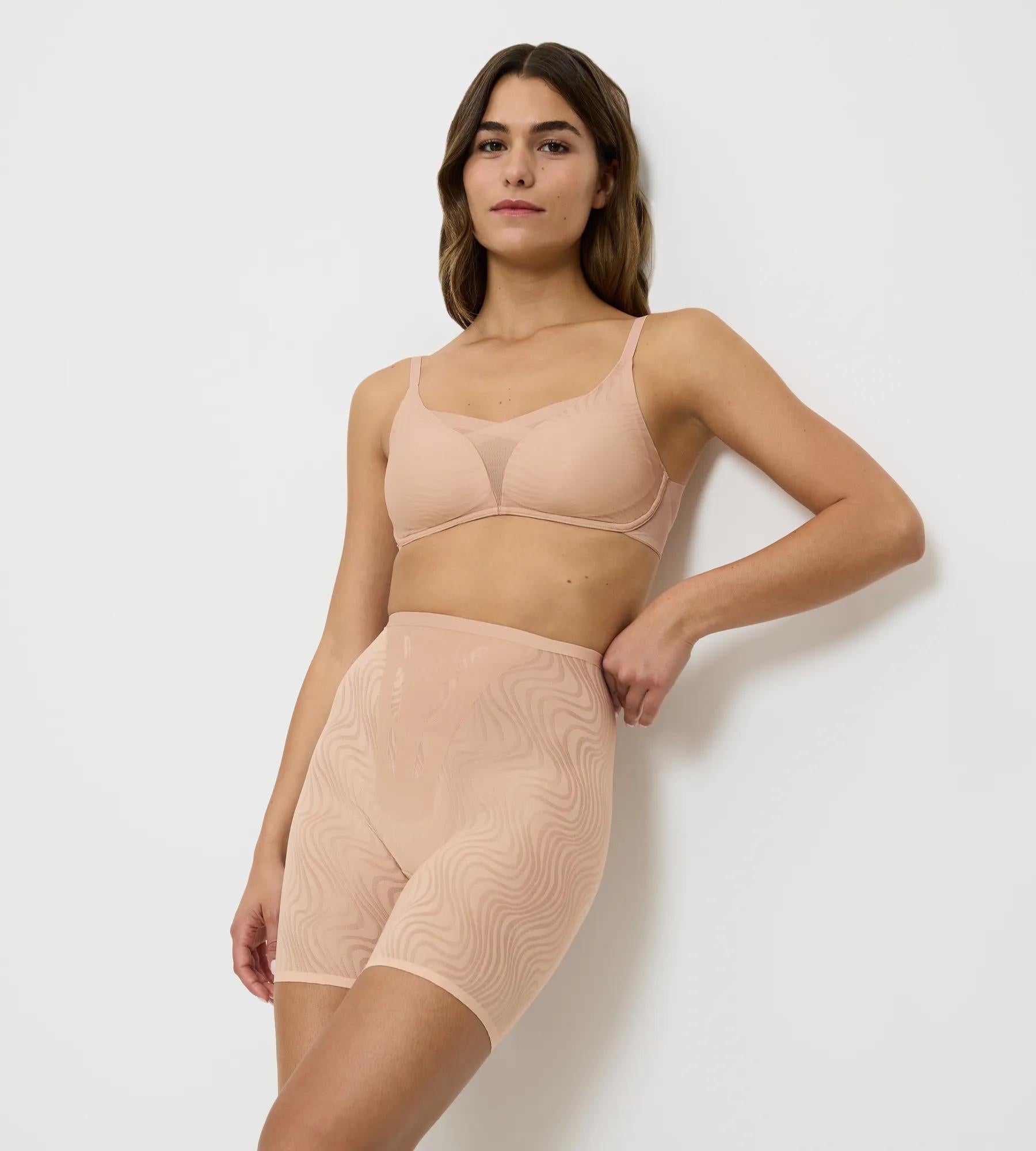 Model wearing Triumph Shape Smart Ellipse bra and shapewear, showcasing smooth silhouette and innovative design.