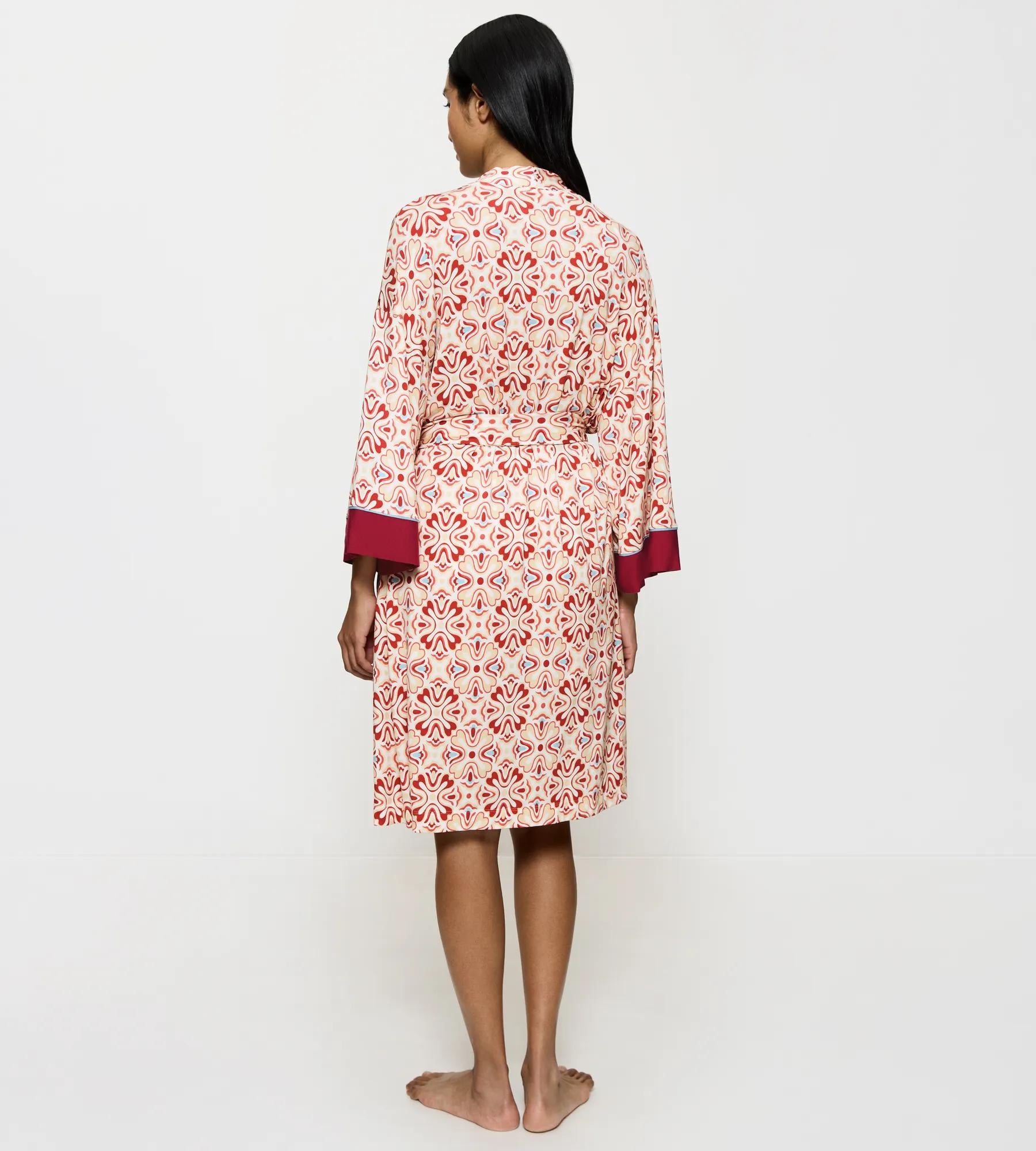 Back view of a woman wearing the Aura Spotlight kimono-inspired robe with elegant pattern.