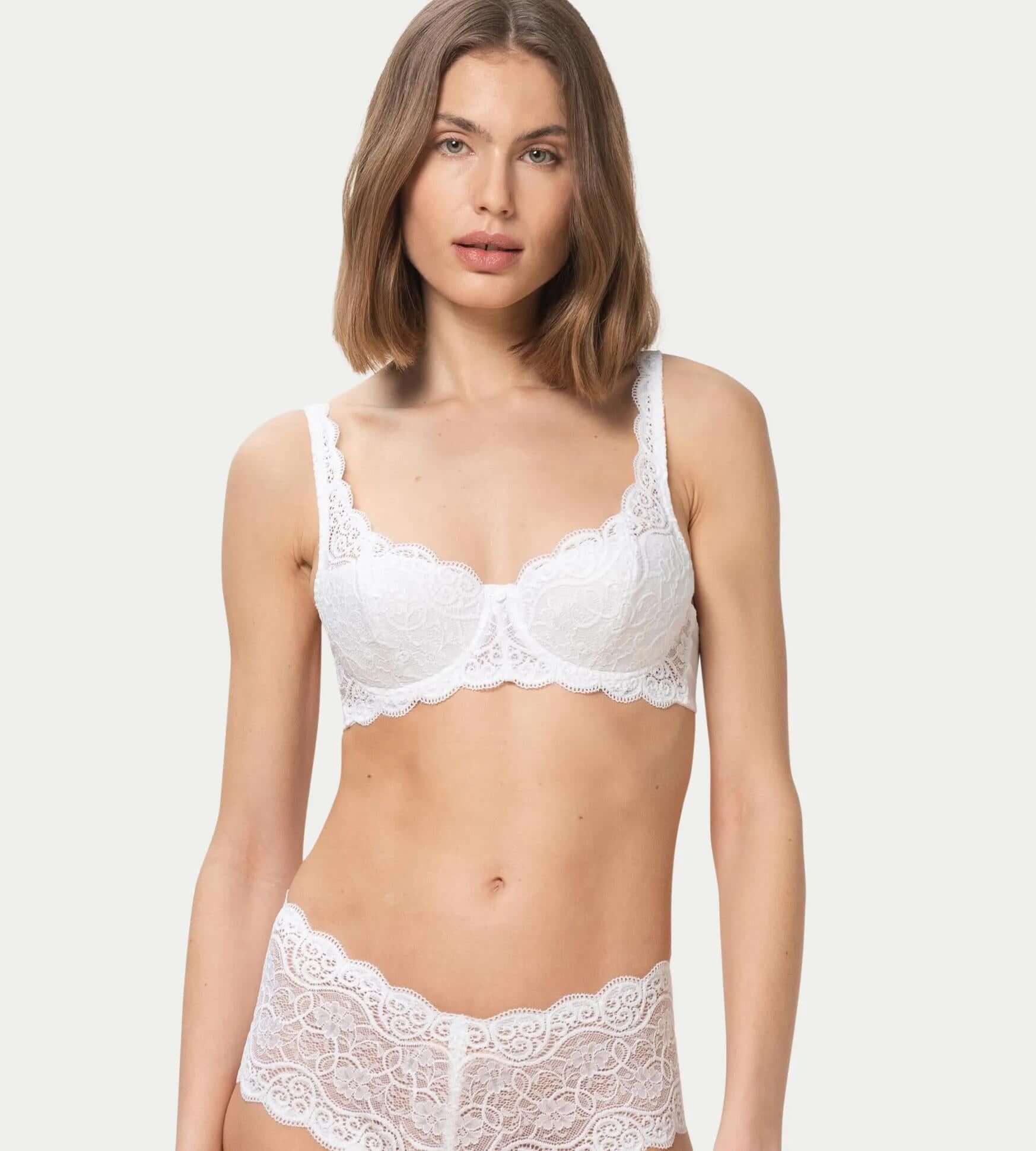 Amourette 300 white bra featuring vintage lace, padded cups, and floral embroidery, styled with matching briefs.
