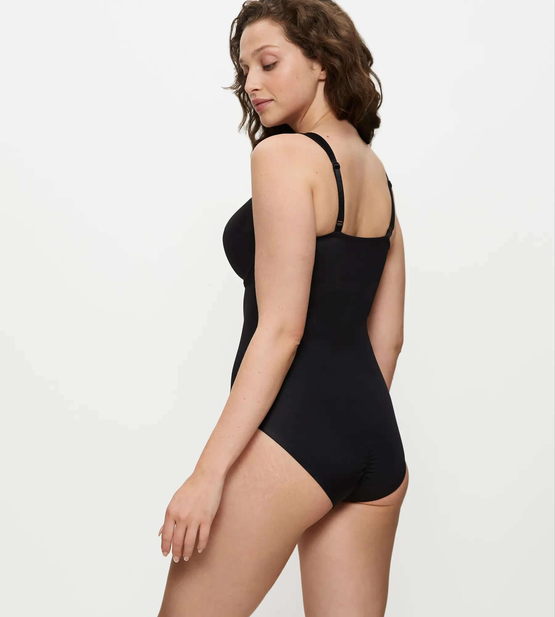 Model wearing the True Shape Sensation bodysuit, showcasing its sleek design and adjustable straps from the back.