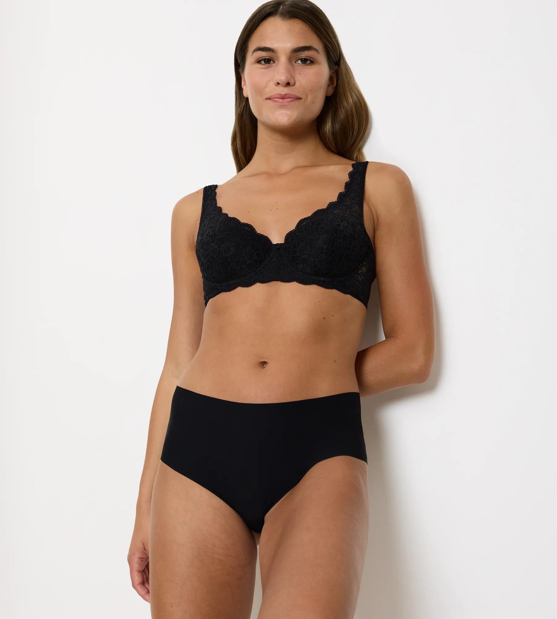 Amourette padded underwired bra in black lace worn with matching black high-waisted panties, showcasing floral design and modern fit.