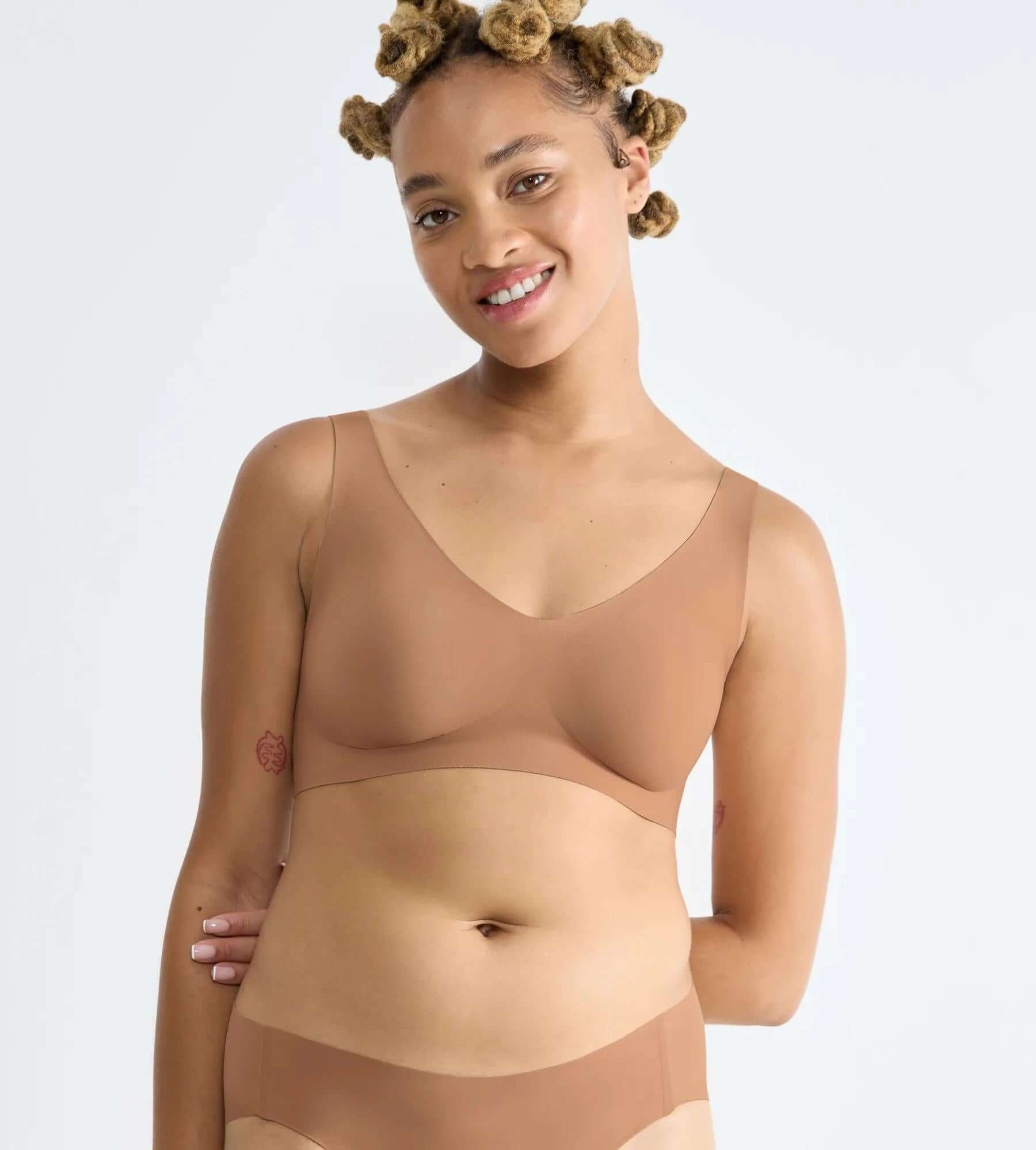 sloggi ZERO Feel bralette on model showcasing seamless design and comfort in a neutral tone.