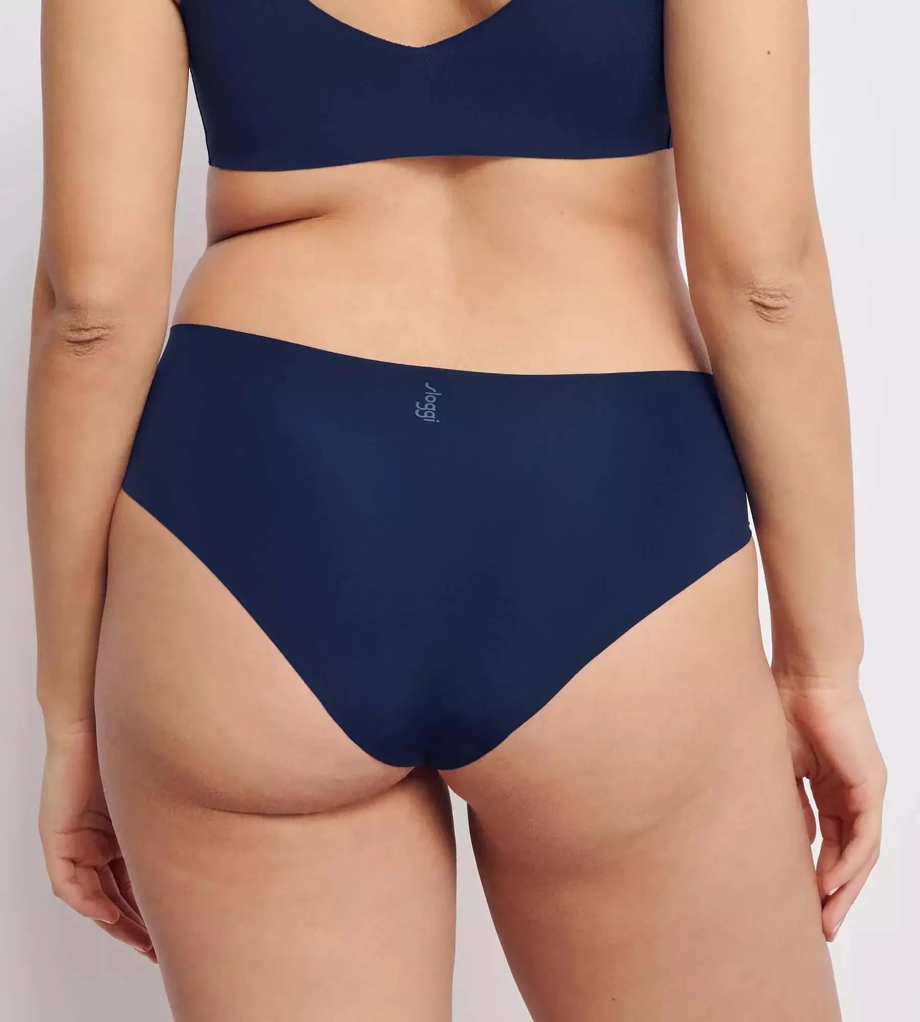 Back view of woman wearing sloggi ZERO Feel hipster briefs in navy, showcasing seamless design and full coverage.