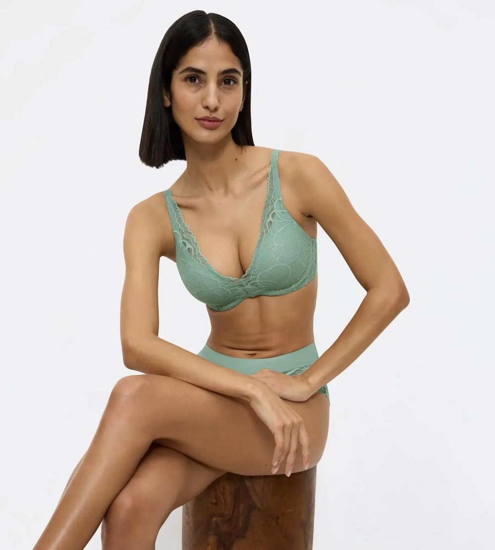 Model showcasing Body Make-Up Illusion Lace bra in green, highlighting the lace design and comfortable fit.