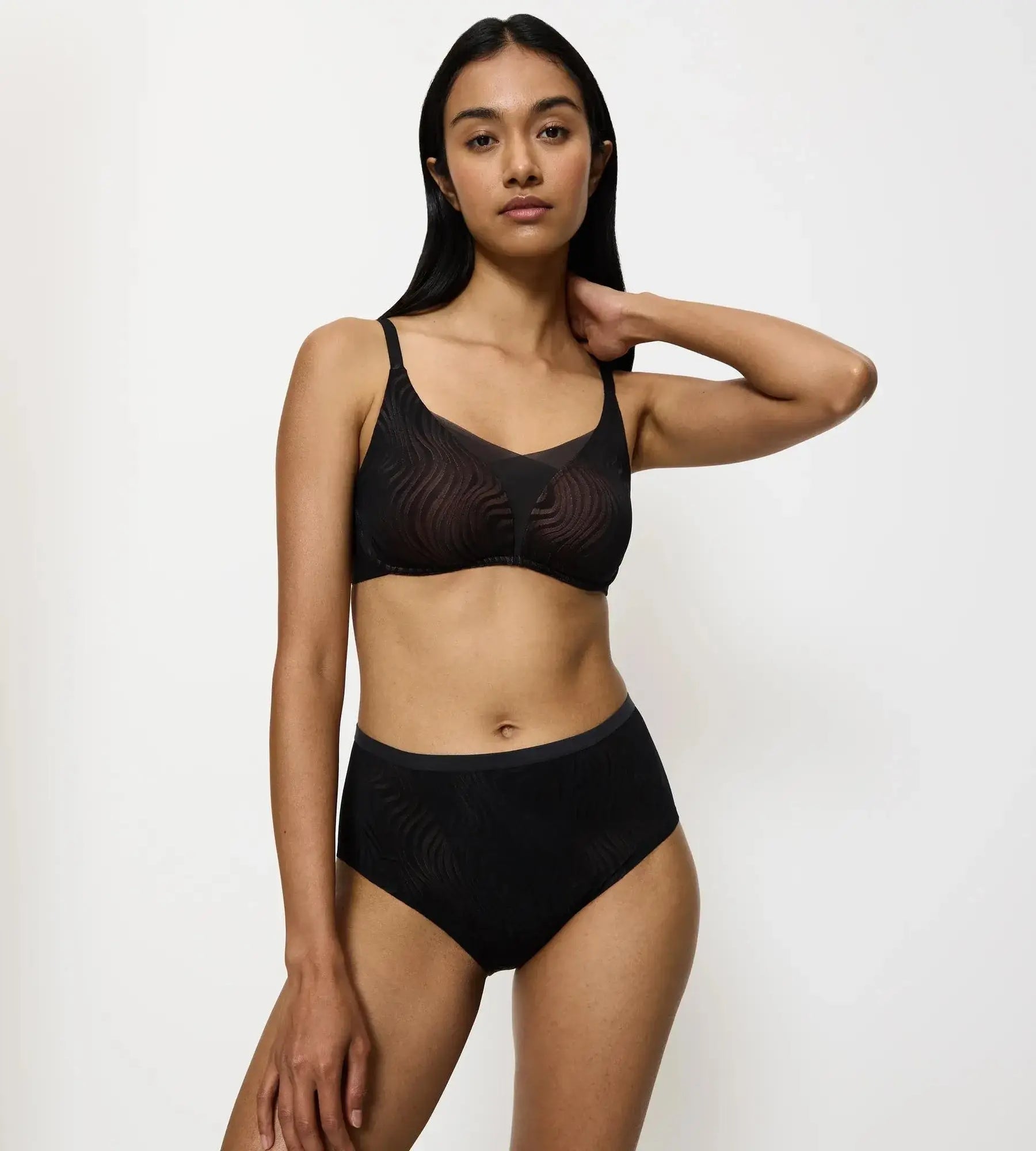 Model wearing a comfortable Triumph Shape Smart Ellipse bikini brief with seamless design and tummy control.