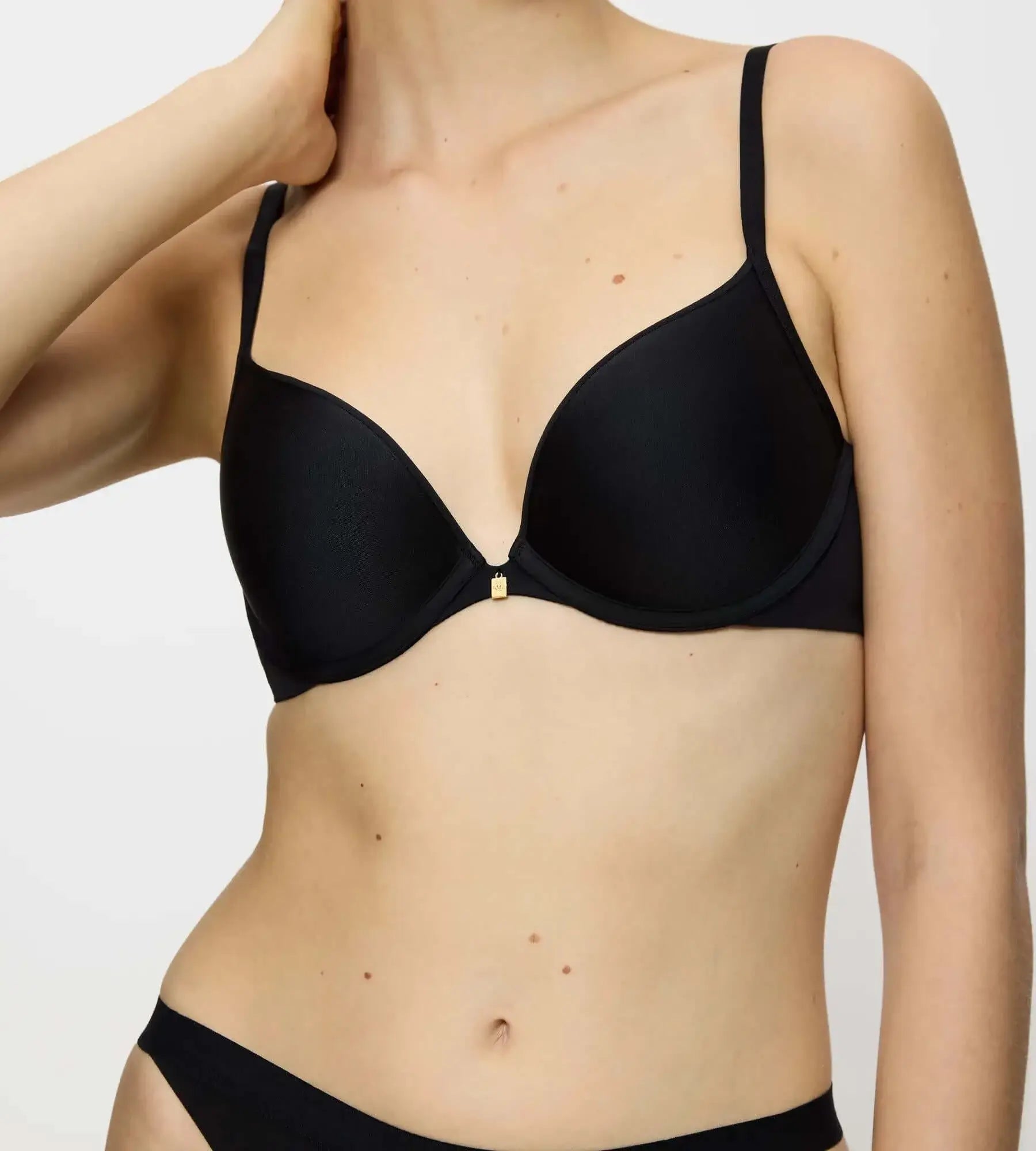 Black body make-up essentials push-up bra featuring padded cups and adjustable straps.