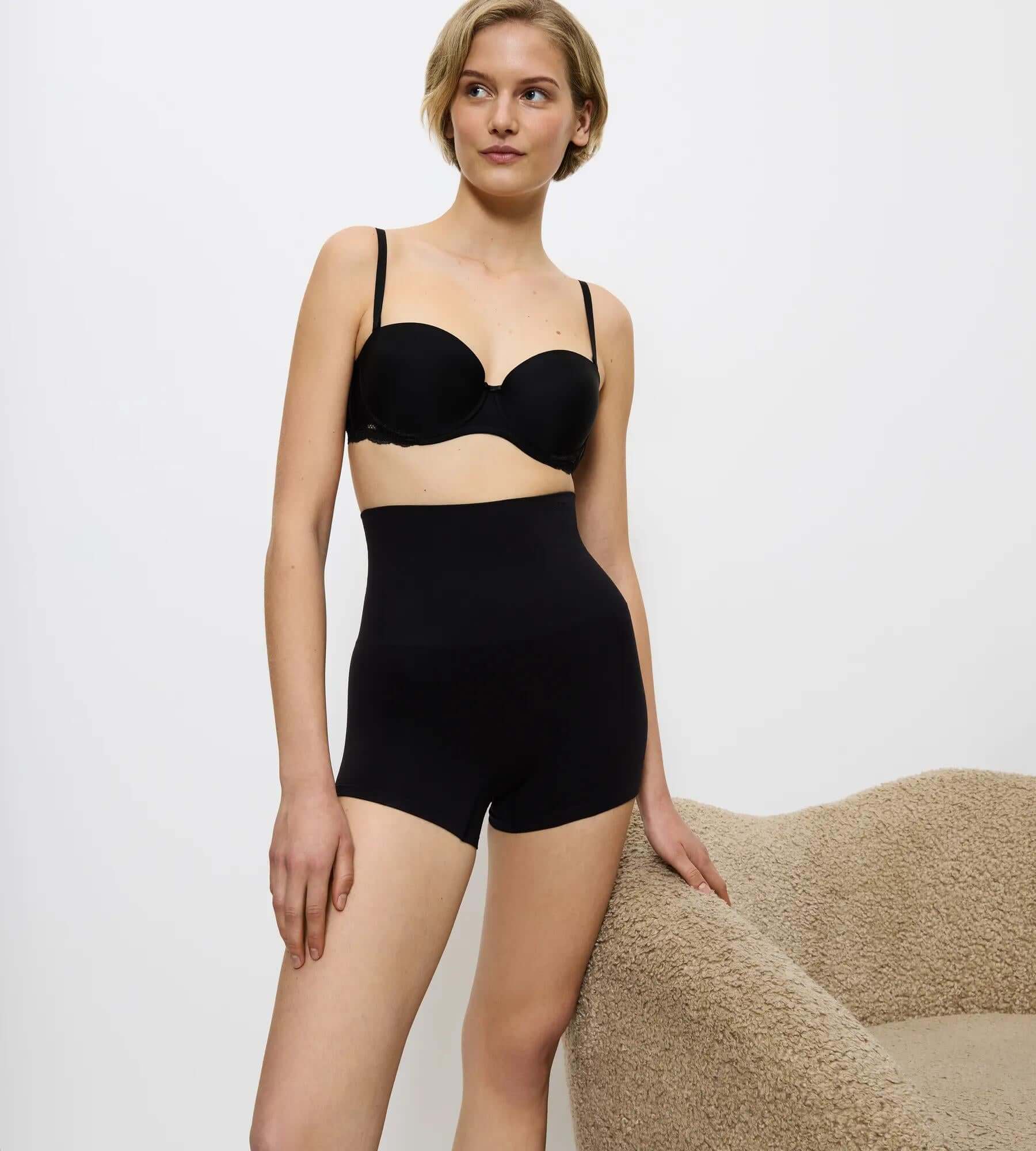 Triumph Soft Sculpt black maximum-coverage short briefs displayed on a model, showcasing comfort and support.